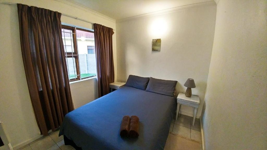 Guest bedroom with a double bed and natural light